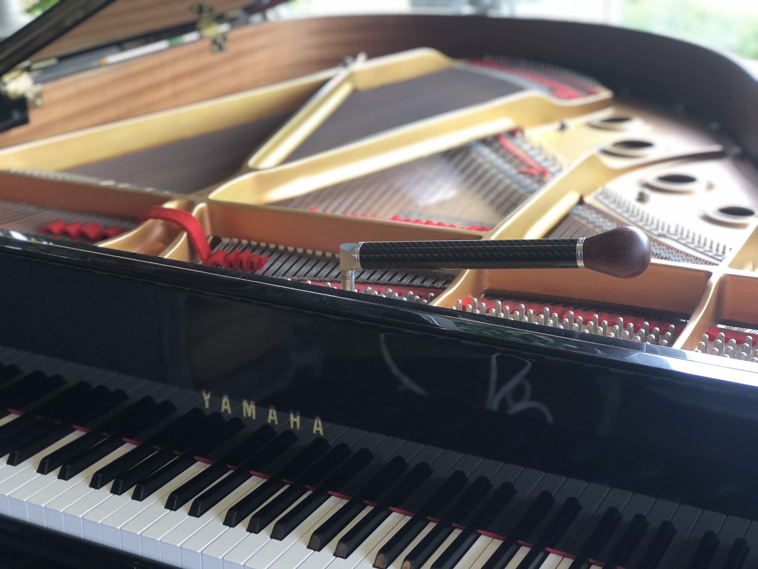 Yamaha grand piano being tuned